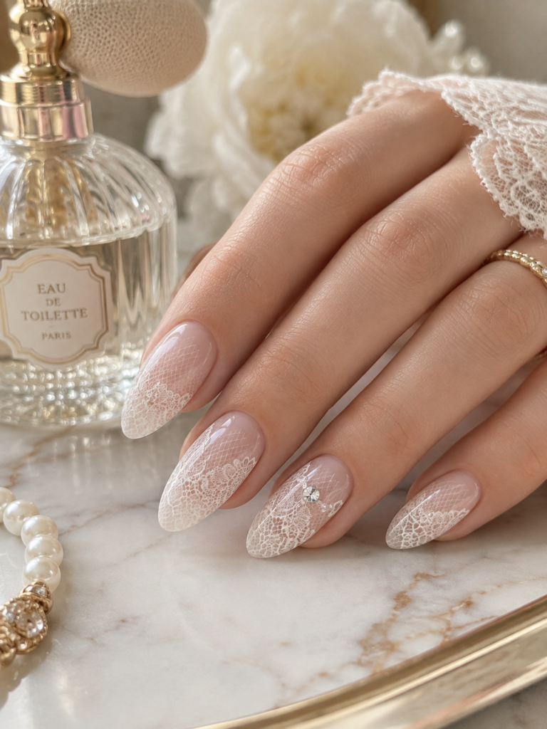 coquette nails with sheer lace-effect white detailing and rhinestone