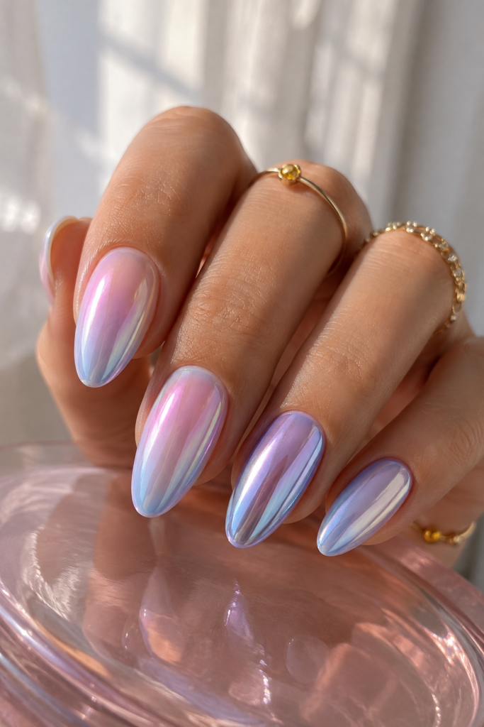 Iridescent pearl nails shifting pink, lilac, and icy blue in light